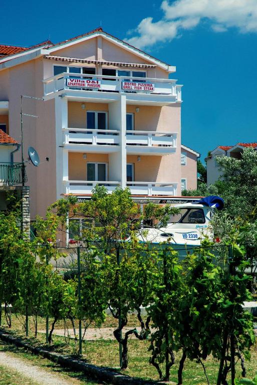 a building with a van parked in front of it at Villa D&I in Vodice