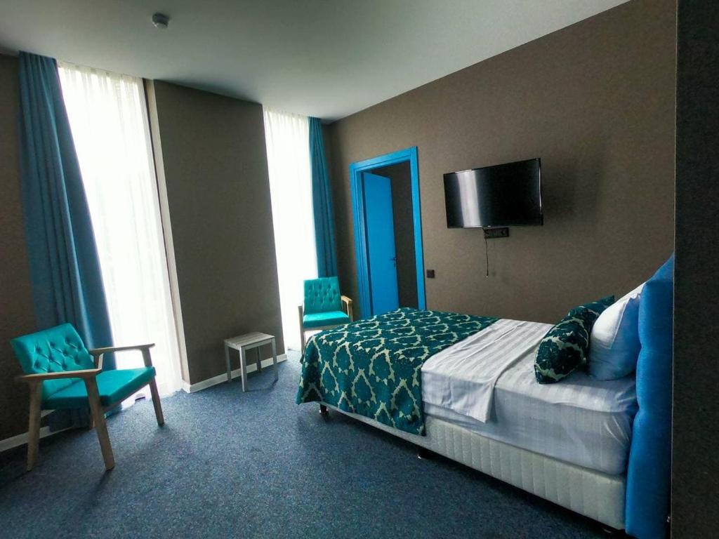 Postel nebo postele na pokoji v ubytování Pano Hotel