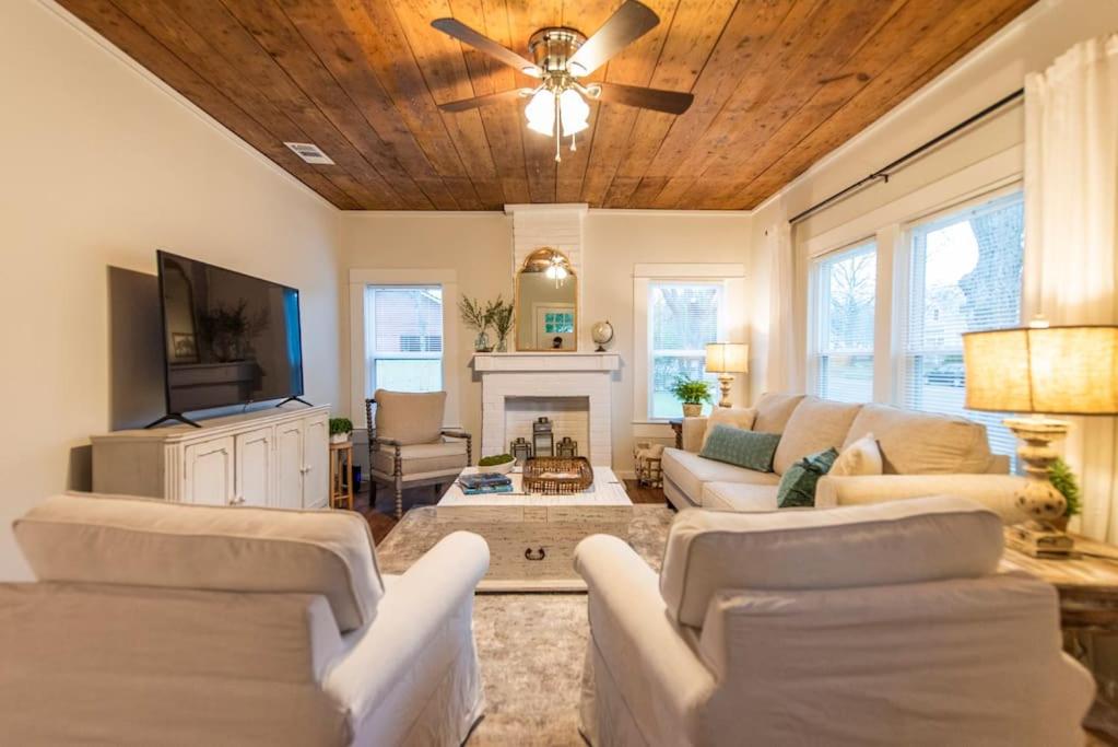 a living room with white furniture and a ceiling fan at NEW-Ethel Rose Cottage-5 min to Magnolia Silos in Waco