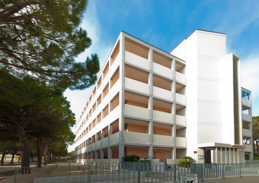 a white office building with trees in front of it at Duca degli Abruzzi in Caorle