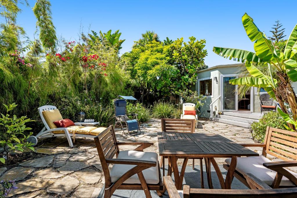 a patio with a table and chairs and a house at Colors of the Coast in Santa Barbara