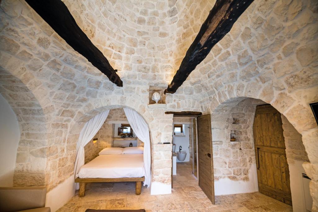 Łóżko lub łóżka w pokoju w obiekcie Il Trullo della Rondinina