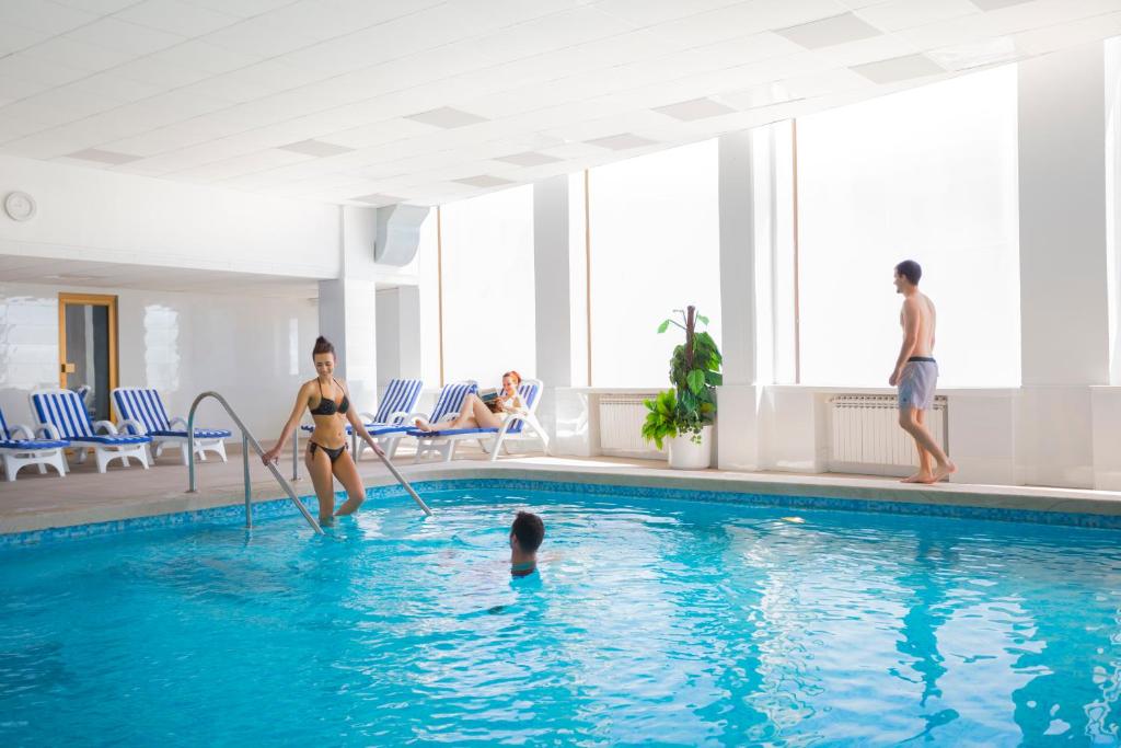 a group of people playing in a swimming pool at Hotel Istra - Liburnia in Opatija