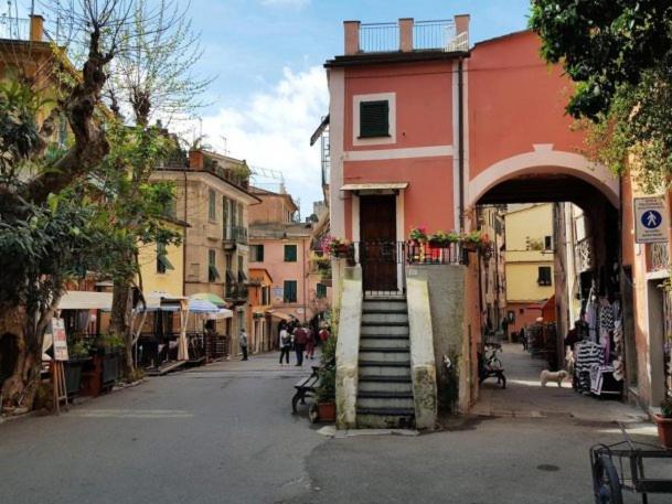 a street with a building with a staircase in the middle at Classic Monterossino Apartment in Old Town in Monterosso al Mare