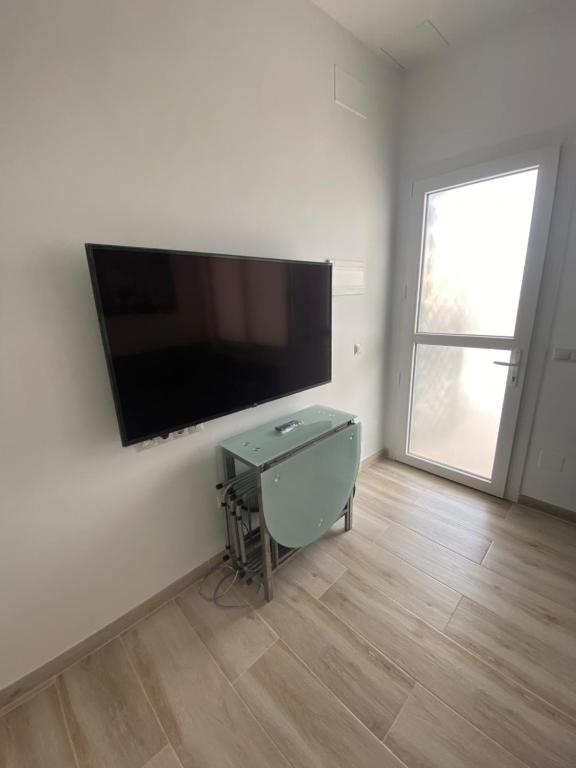a living room with a flat screen tv on a wall at Apartamentos BEACHYDAYS Montalvo in Torremolinos