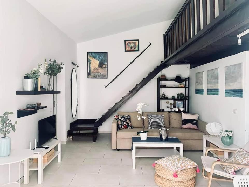 a living room with a couch and a staircase at The Perfect Stay Maspalomas in Maspalomas