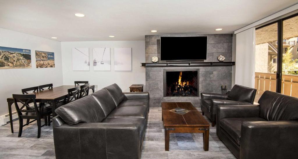 a living room with a couch and a fireplace at Scorpio #104 Condo in Vail