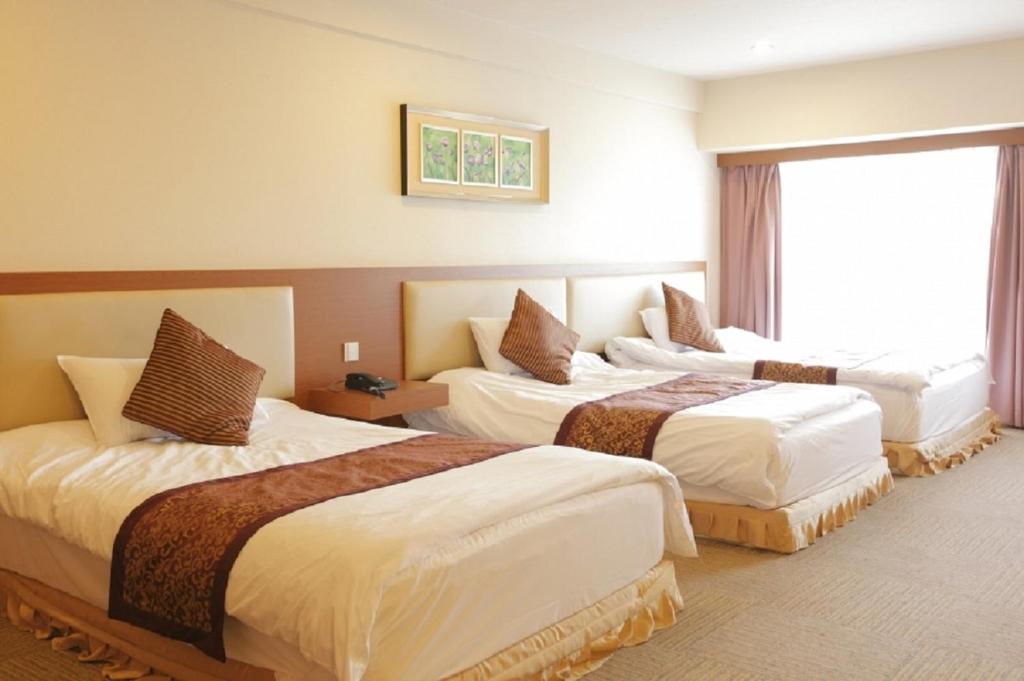 Postel nebo postele na pokoji v ubytování Fujisan Garden Hotel
