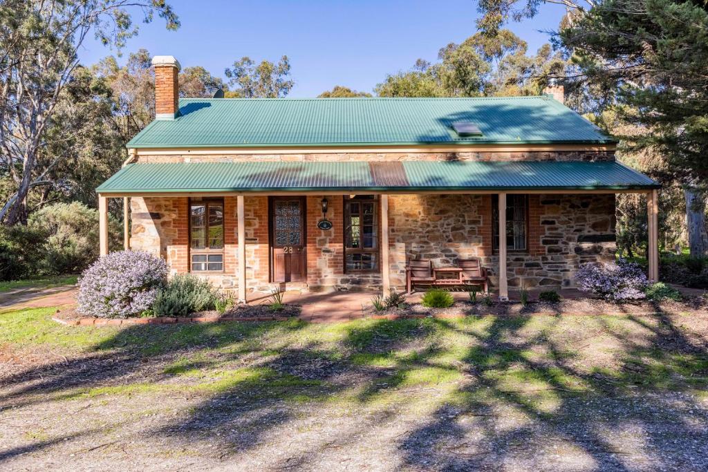 an old stone house with a green roof at Lemke Cottage Barossa Valley in Moculta