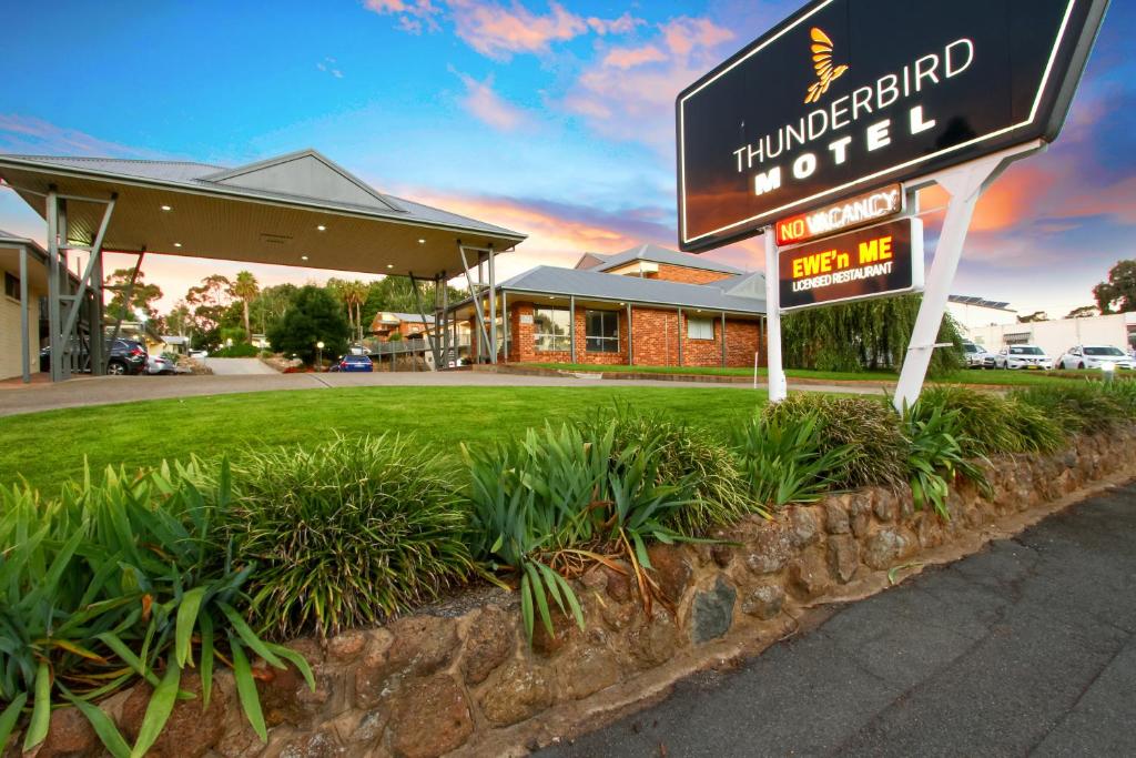 a sign for a hotel in front of a building at Thunderbird Motel Yass in Yass