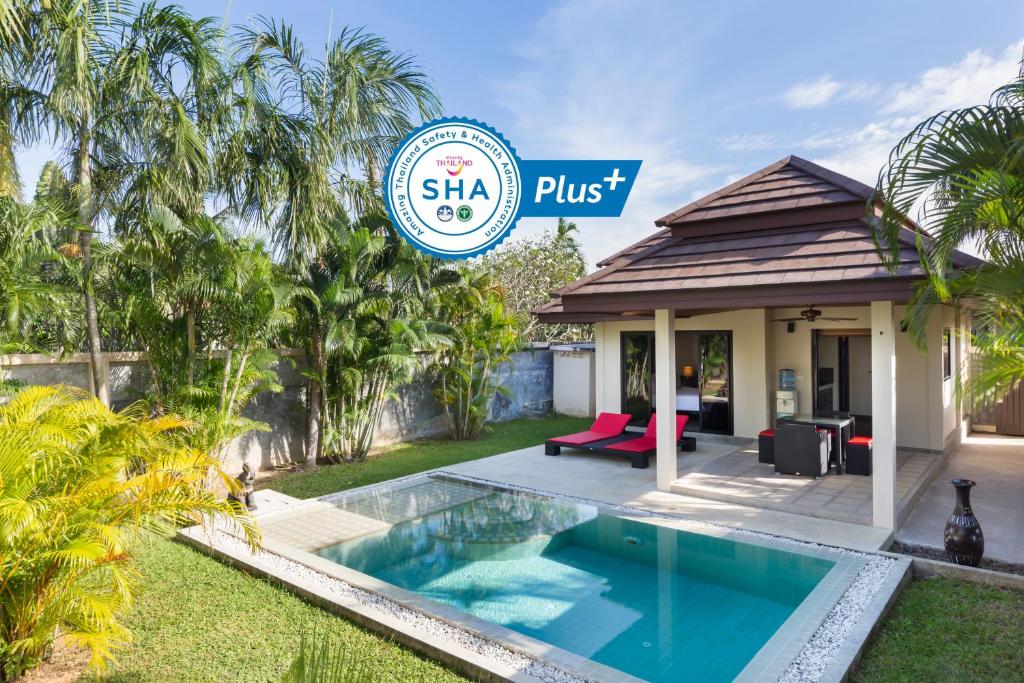 a villa with a swimming pool in a yard at Phuket Pool Residence - Adults only in Rawai Beach