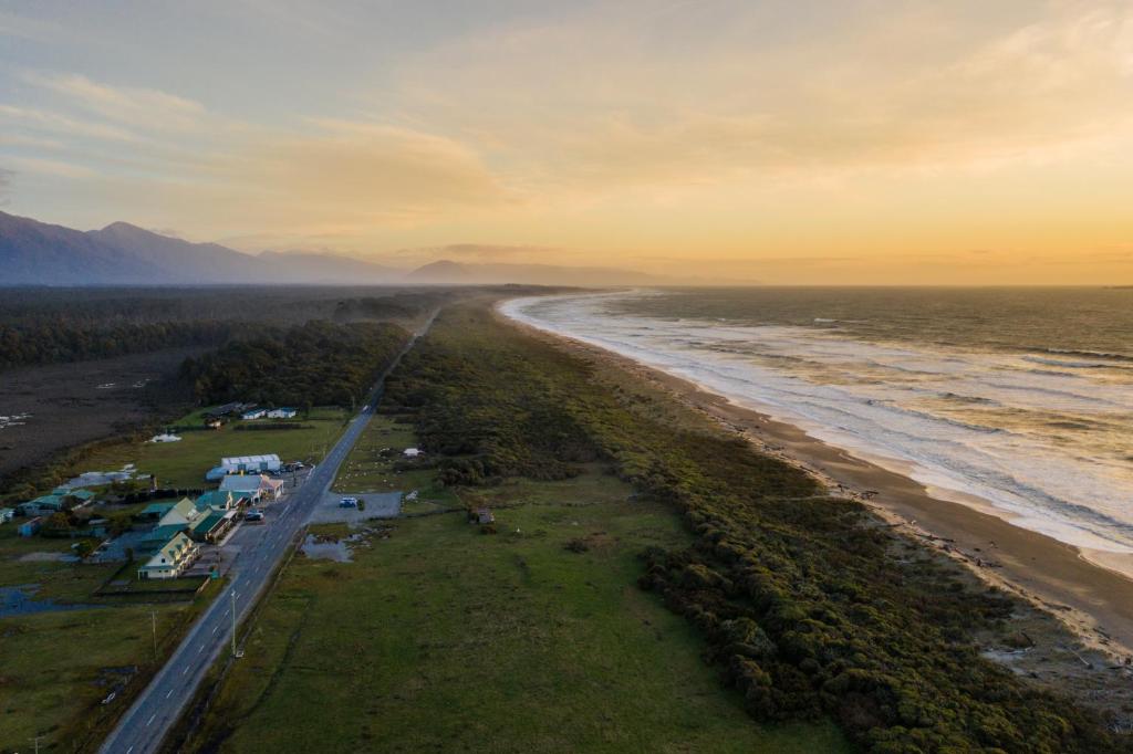 an aerial view of a beach and the ocean at Haast Beach Motel in Haast