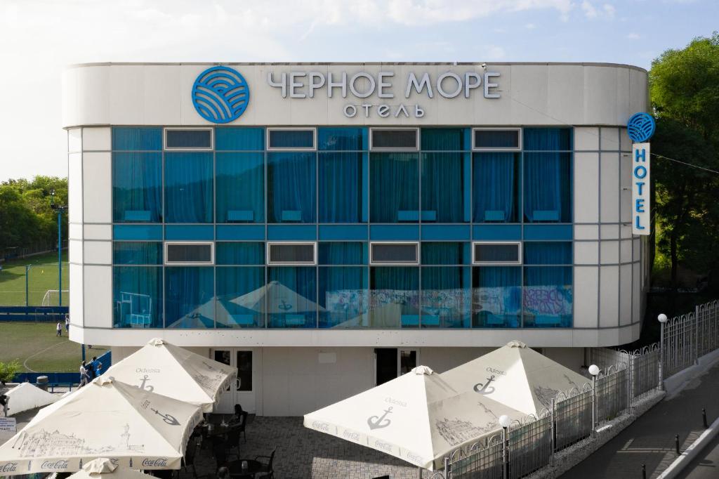 a large office building with umbrellas in front of it at Black Sea Hotel Otrada in Odesa