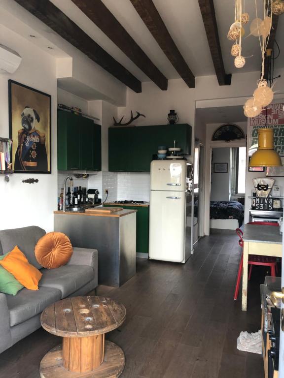 a kitchen and living room with a couch and a table at Milano Suite Lights in Milan