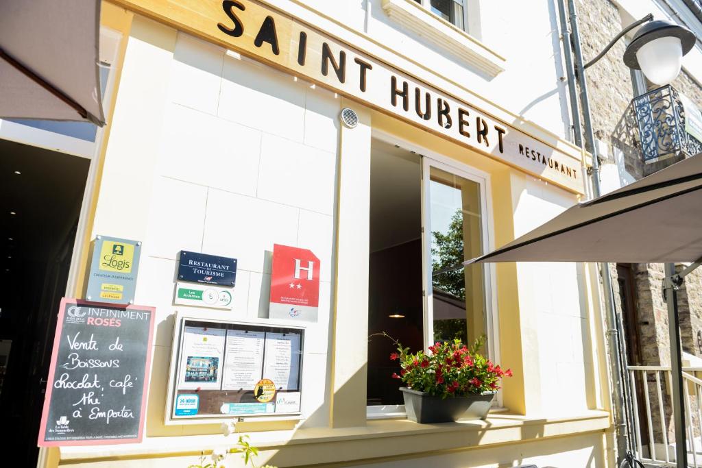 a store front of a restaurant with a sign on it at Logis Le Saint Hubert in Haybes