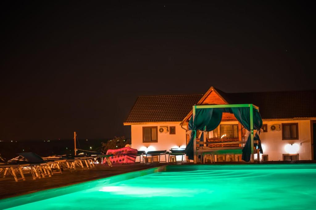a house with a swimming pool at night at Relax in Greci