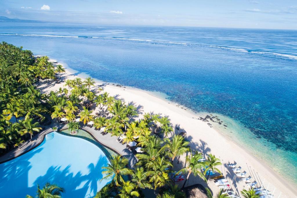 an aerial view of a beach with palm trees and the ocean at Victoria Beachcomber Resort & Spa in Pointe aux Piments