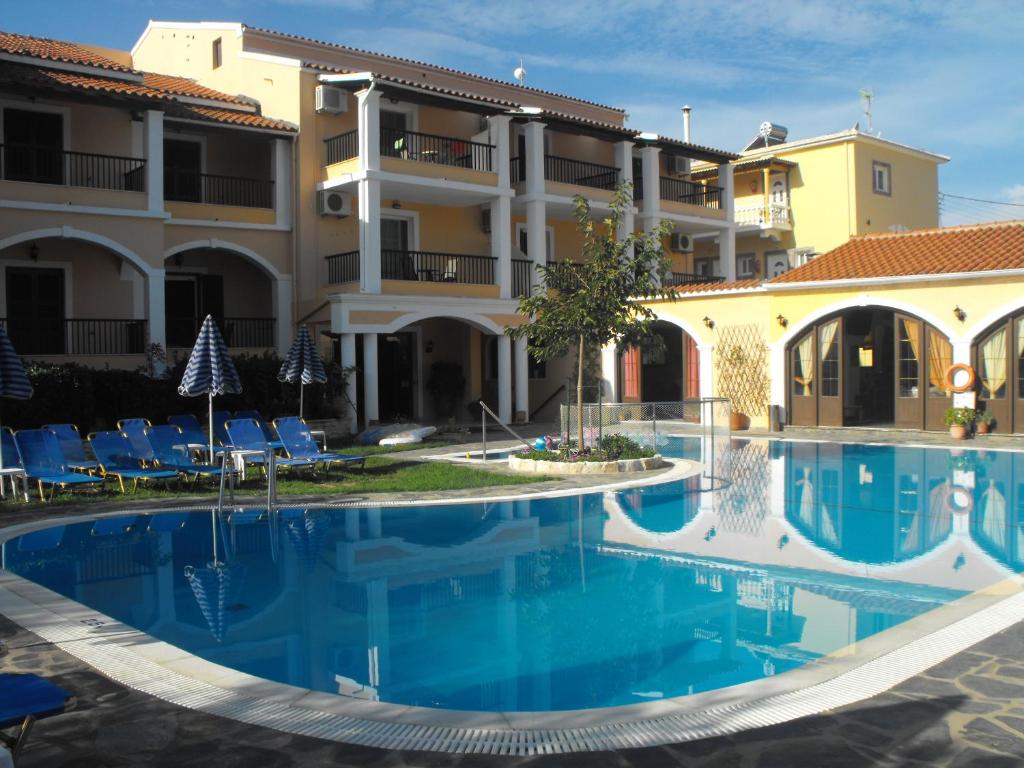a view of the hotel from the pool at Perros Hotel in Agios Stefanos