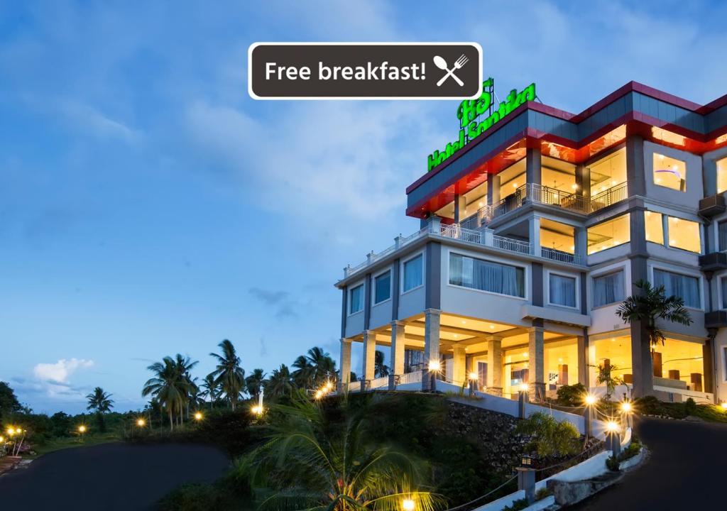 a hotel with a sign that reads free breakfast at Hotel Santika Luwuk - Sulawesi Tengah in Luwuk