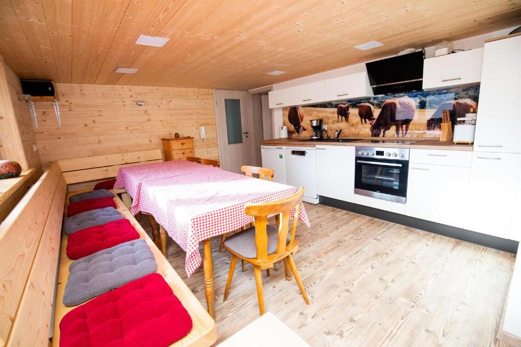 a kitchen with a table and a dining room at Ferienwohnungen Schmitt in Ehrenberg in Ehrenberg