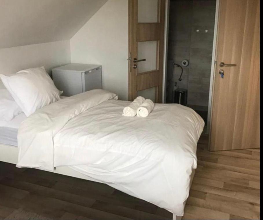 a white bed with two towels on top of it at Apartment Oskar in HoÅ¡Å¥ka
