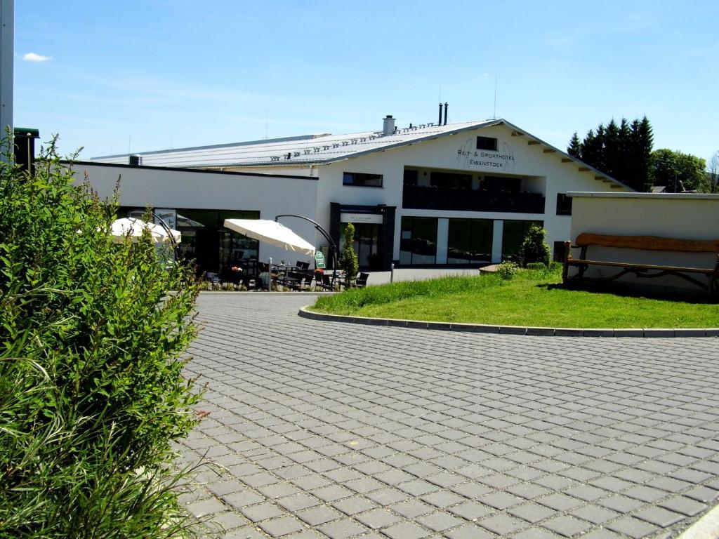 a building with a bench in front of it at Reit- und Sporthotel Eibenstock in Eibenstock