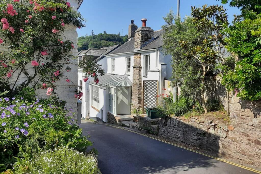 a row of houses in a village with flowers at The Cottage , Newton Ferrers in Newton Ferrers