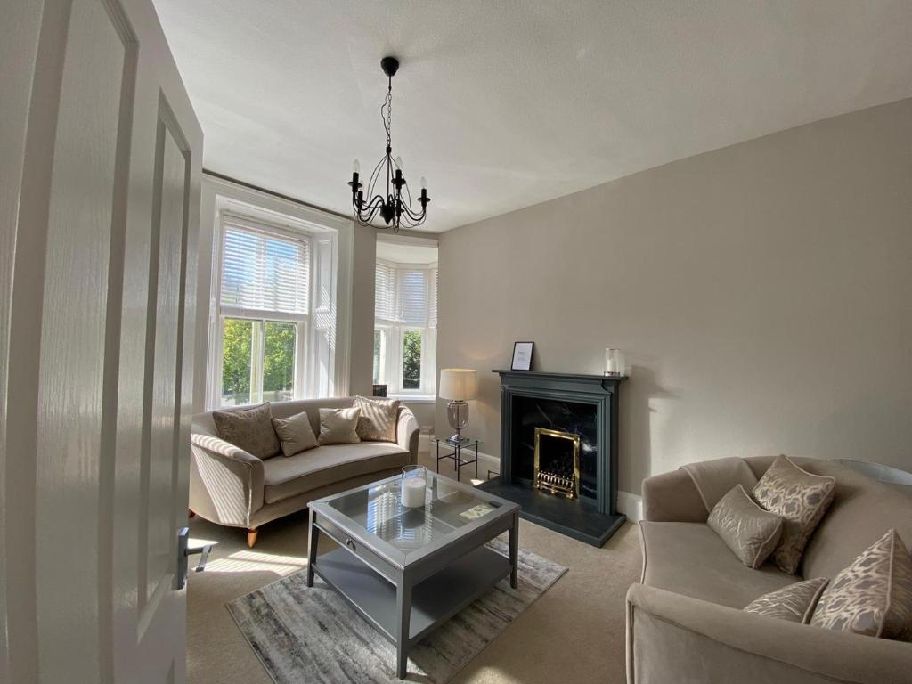 a living room with two couches and a fireplace at Lovely Entire Flat in Birnam, neighbouring Dunkeld in Birnam