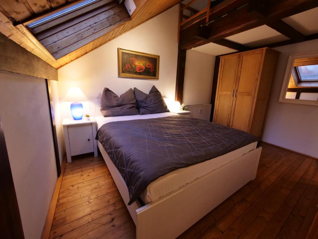 a bedroom with a large bed in a room at Fachwerkhaus in ruhiger Altstadt by Rabe - free Netflix & eigene Terrasse in Karlsruhe