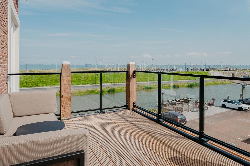 a balcony with a view of a body of water at Residence Oude Haven Colijnsplaat appartementen met verdieping in Colijnsplaat
