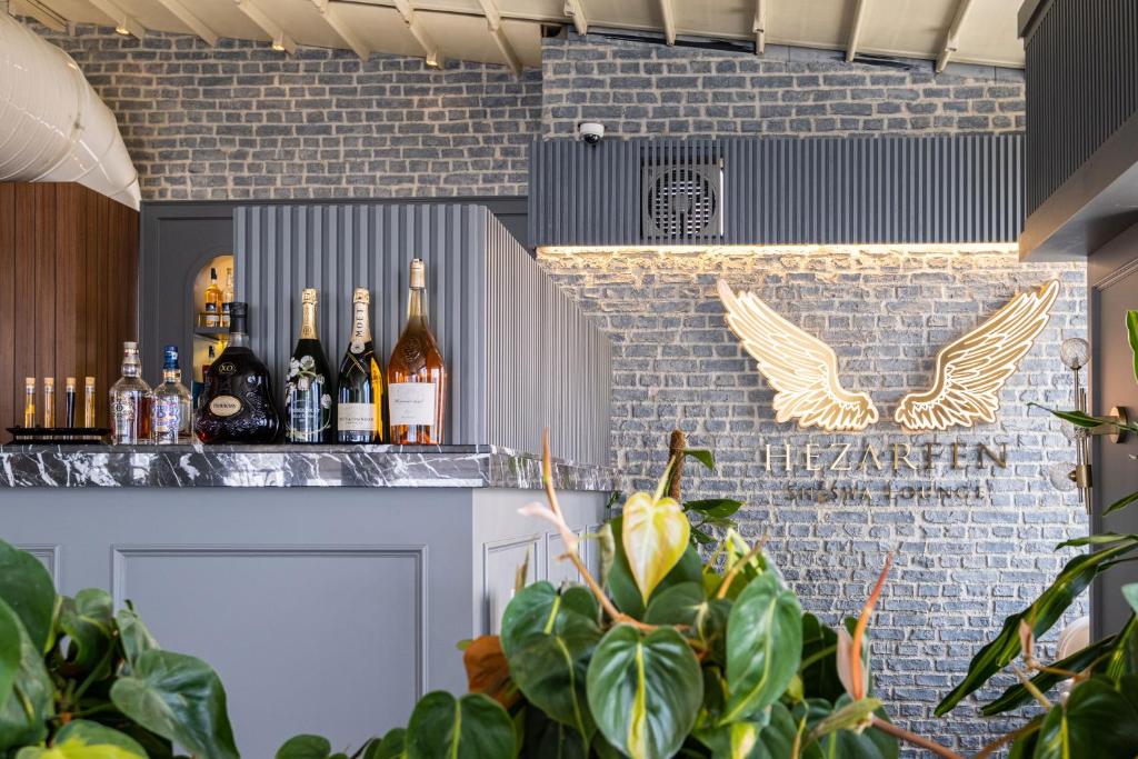 a bar with bottles of wine on a brick wall at CVK Park Bosphorus Hotel Istanbul in Istanbul