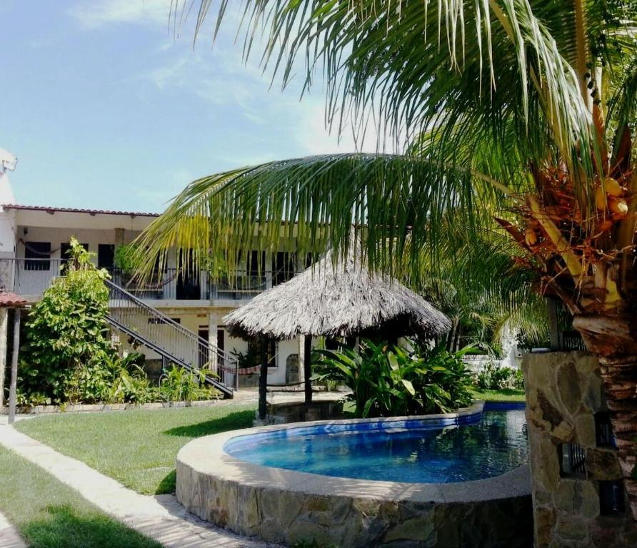 una piscina en un patio con una palmera en Casa Nova, en Puerto Colombia