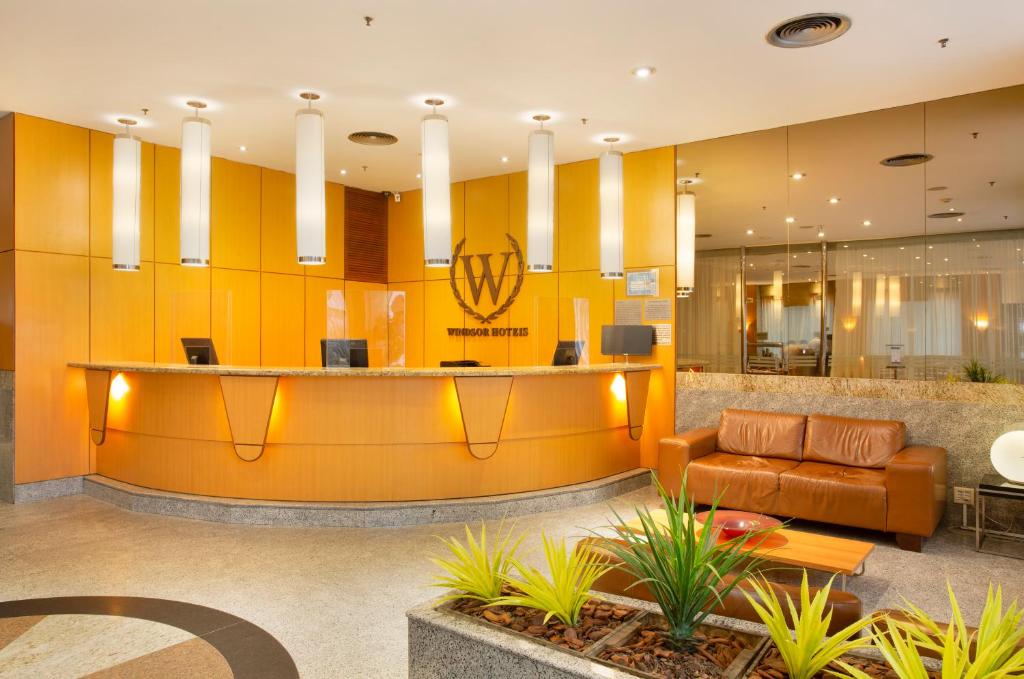 a lobby with a couch and a reception desk at Windsor Asturias Hotel in Rio de Janeiro