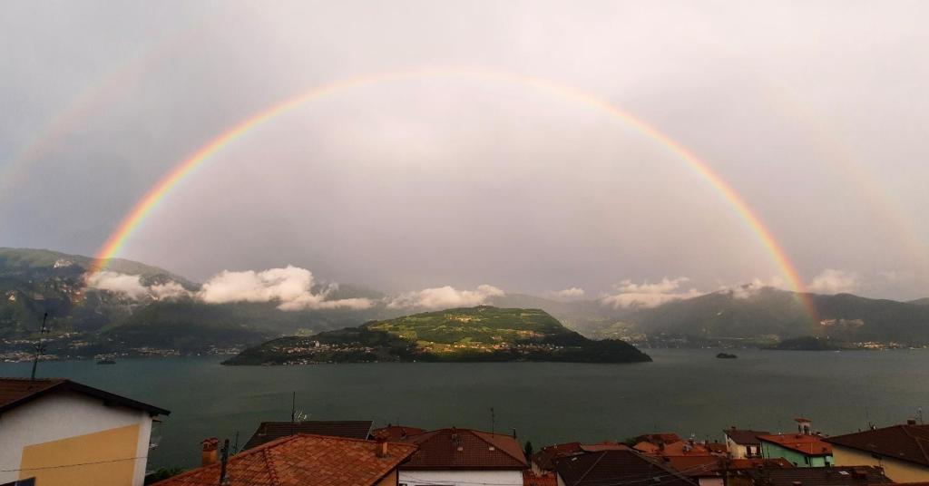 a double rainbow over a body of water at Casa Magotina in Tavernola Bergamasca
