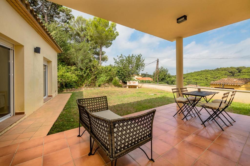 a patio with chairs and a table with a view at RB-5 RESIDENCIAL BEGUR 6 PaX in Begur