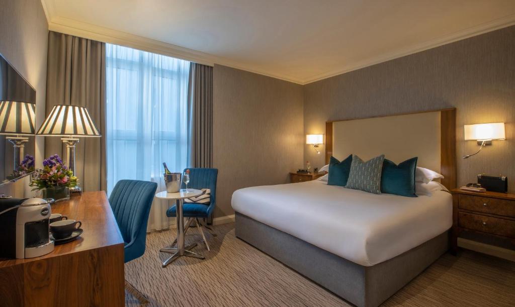 una camera d'albergo con letto e scrivania di The Victoria Hotel a Galway