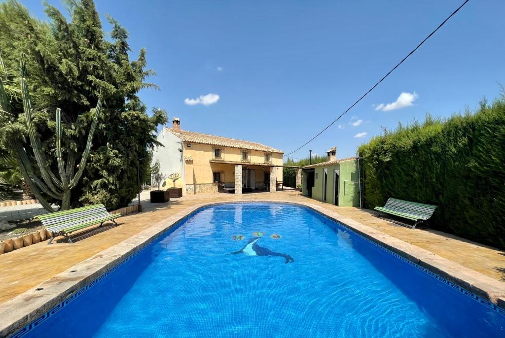 a swimming pool in front of a house at Chalet en Librilla in Murcia