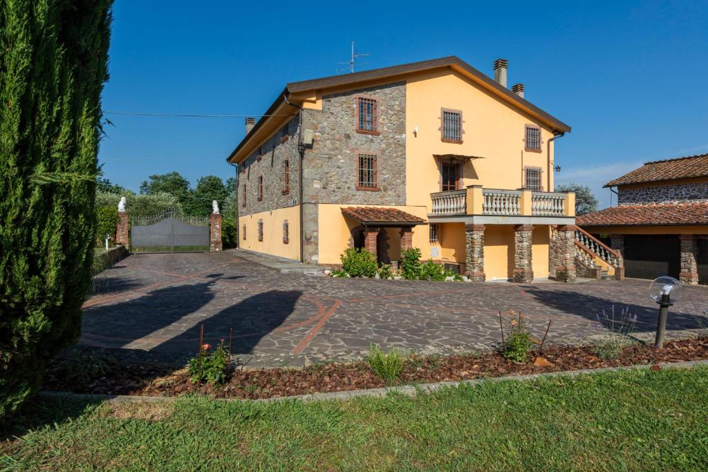 una grande casa in pietra con un grande vialetto di Villa Leone a San Gennaro
