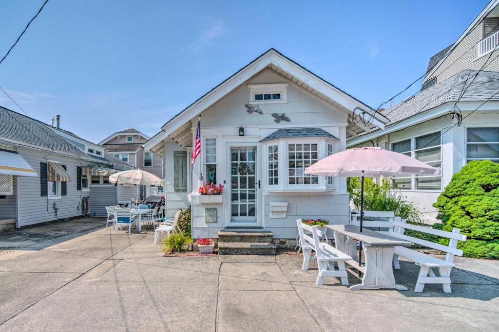 a house with tables and umbrellas in front of it at Darling Ocean City Cottage, 2 Blocks to Beach! in Ocean City