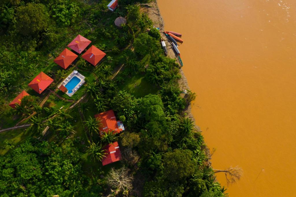 an overhead view of a hill with trees and water at Monte Amazonico Lodge in Tambopata