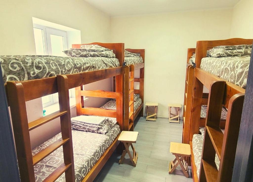 a room with four bunk beds in a room at Uman Welcome Hostel in Umanʼ