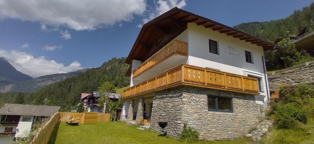 a house with a balcony on the side of it at Haus Fien in Heiligenblut