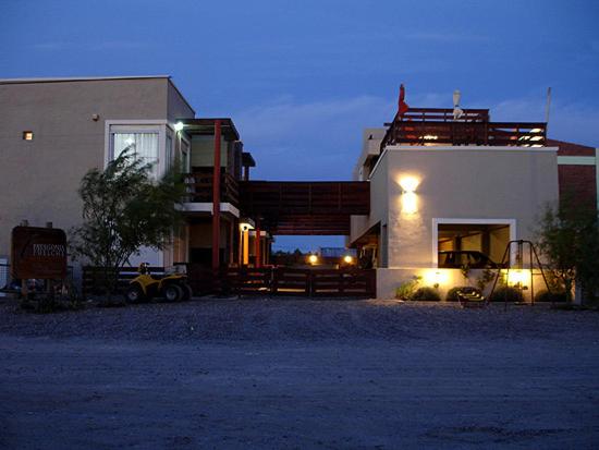 a house with lights on the side of it at Guardalaola Patagonia Puelche in Las Grutas