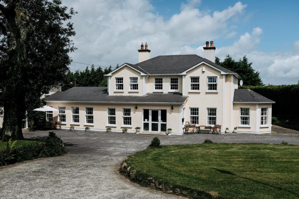 a large white house with a lot of windows at Glenhill B&B in Wexford