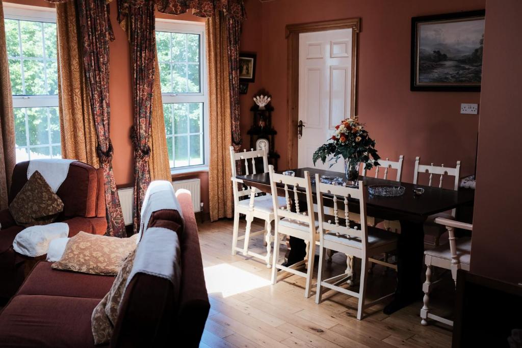 a living room with a table and chairs and a couch at Glenhill B&B in Wexford