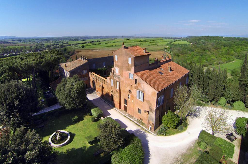 an aerial view of a large brick house with a yard at Castello del Duca in Marcigliana