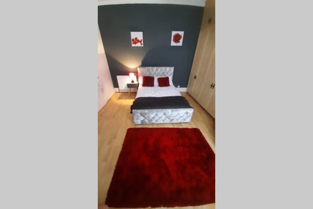 a room with a bed and a red rug at Sunderland short stay 2-bed retreat apartment in Fulwell in Monkwearmouth