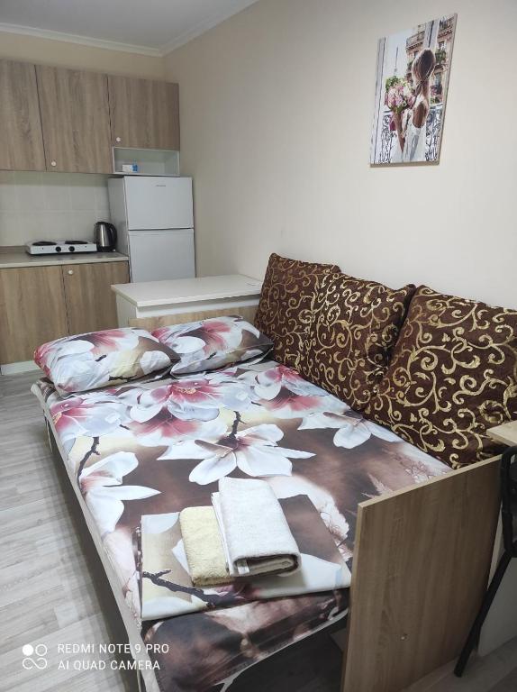 a bed in a living room next to a couch at Коттедж Науки 65 in Kharkiv