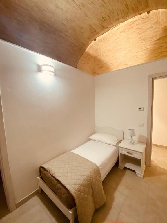 A bed or beds in a room at RELAIS SAN MARCO LUXURY GUEST HOUSE