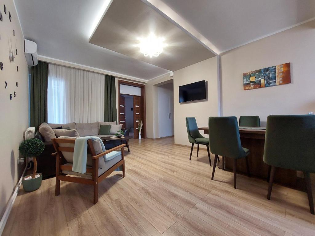 un soggiorno con divano, tavolo e sedie di Vively Lux Apartment a Subotica